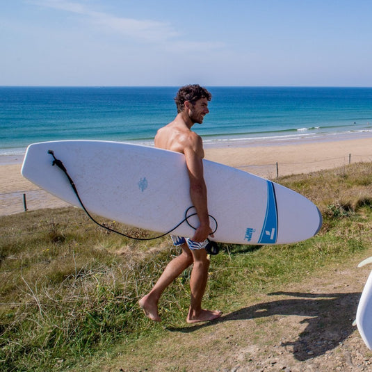 Tahe 7 ft 9 Malibu Rigid Surf Board Action Shot Surfer carrying board to the beach